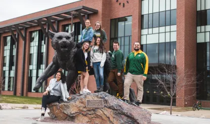 ONC students standing around the Wildcat statue in front of Jamrich Hall.